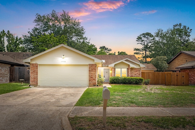 ranch-style house with fence, driveway, brick siding, and a front yard