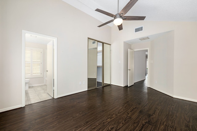 interior space with baseboards, high vaulted ceiling, visible vents, and wood finished floors