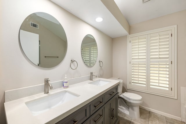 bathroom with toilet, tile patterned floors, visible vents, and a sink