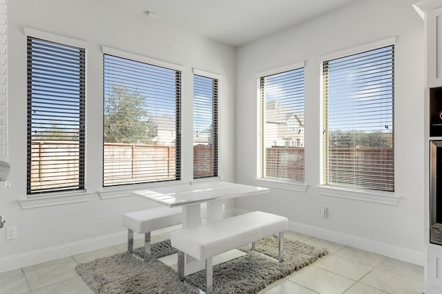 dining room featuring light tile patterned floors and baseboards