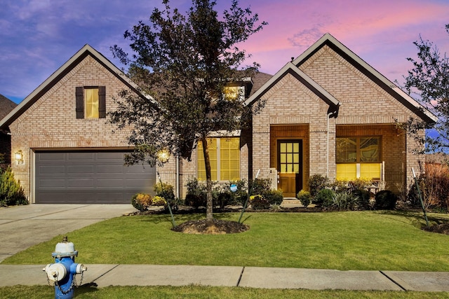 view of front facade with concrete driveway, a front yard, brick siding, and a garage