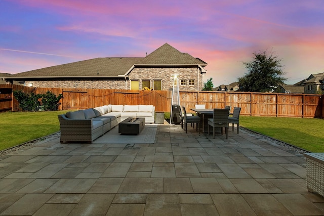 patio terrace at dusk featuring an outdoor living space with a fire pit and outdoor dining area