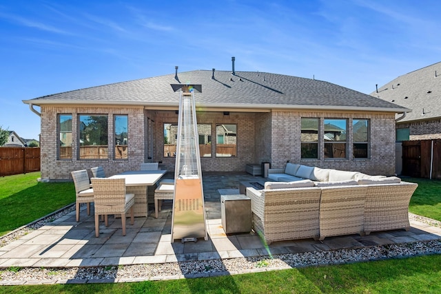 rear view of house featuring outdoor lounge area, brick siding, a patio, roof with shingles, and outdoor dining area