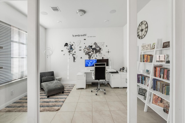 office with tile patterned floors and healthy amount of natural light