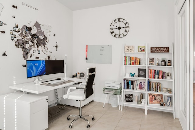 office space with tile patterned floors and baseboards