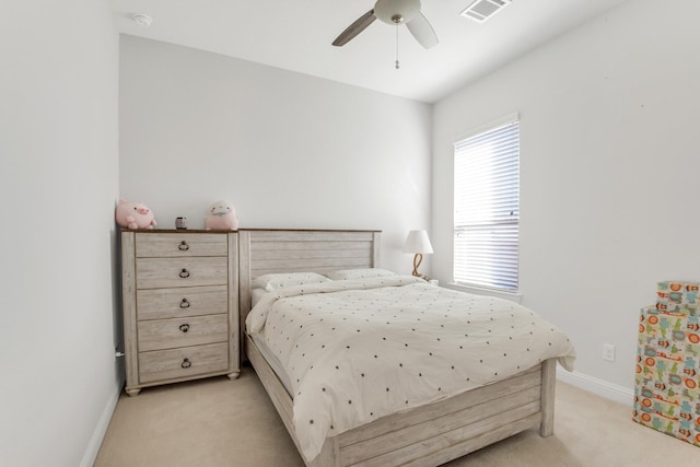 bedroom with light colored carpet, baseboards, and a ceiling fan