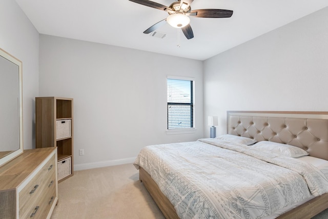 bedroom featuring light carpet, baseboards, and a ceiling fan