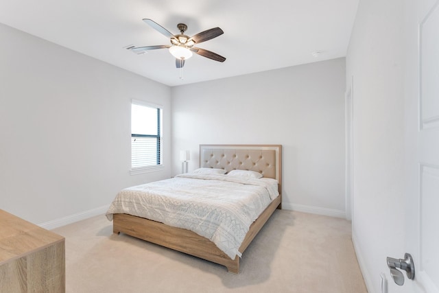 bedroom featuring light carpet, baseboards, and ceiling fan