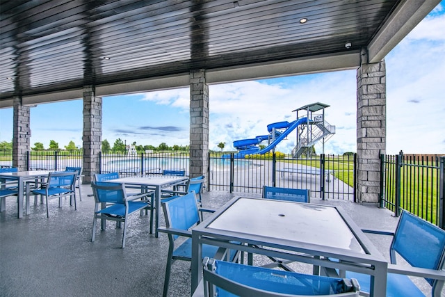 view of patio with outdoor dining space and fence