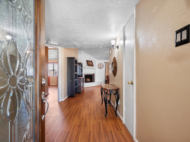 11602 Stone Bridge Dr, Houston, TX 77064 - hall with wood finished floors, a textured ceiling, and baseboards