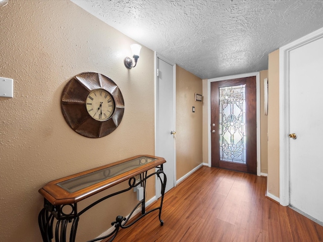 11602 Stone Bridge Dr, Houston, TX 77064 - foyer entrance featuring a textured ceiling, wood finished floors, and baseboards