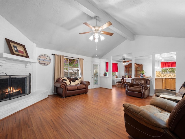 11602 Stone Bridge Dr, Houston, TX 77064 - living area featuring a ceiling fan, wood finished floors, a fireplace, and a textured ceiling