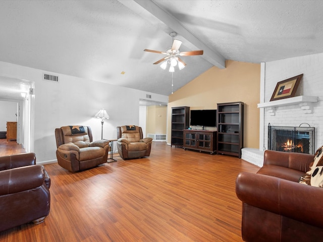 11602 Stone Bridge Dr, Houston, TX 77064 - living area featuring a fireplace, a ceiling fan, wood finished floors, a textured ceiling, and baseboards