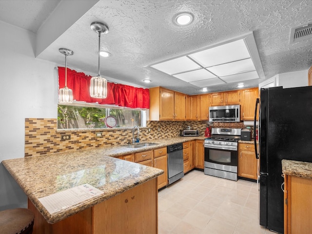 11602 Stone Bridge Dr, Houston, TX 77064 - kitchen featuring stainless steel appliances, a sink, a peninsula, tasteful backsplash, and pendant lighting