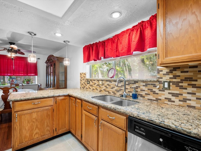 11602 Stone Bridge Dr, Houston, TX 77064 - kitchen with stainless steel dishwasher, a sink, ceiling fan, a textured ceiling, and a peninsula