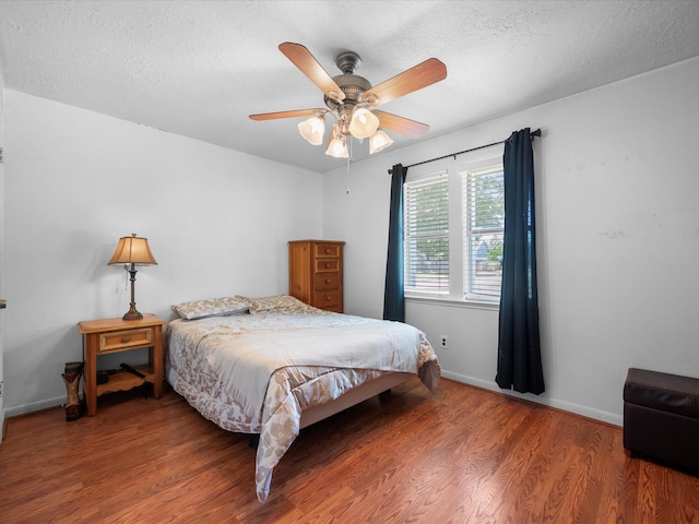 11602 Stone Bridge Dr, Houston, TX 77064 - bedroom featuring wood finished floors, baseboards, a ceiling fan, and a textured ceiling