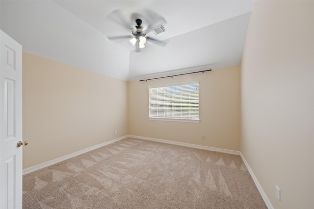 empty room with visible vents, lofted ceiling, light carpet, baseboards, and ceiling fan