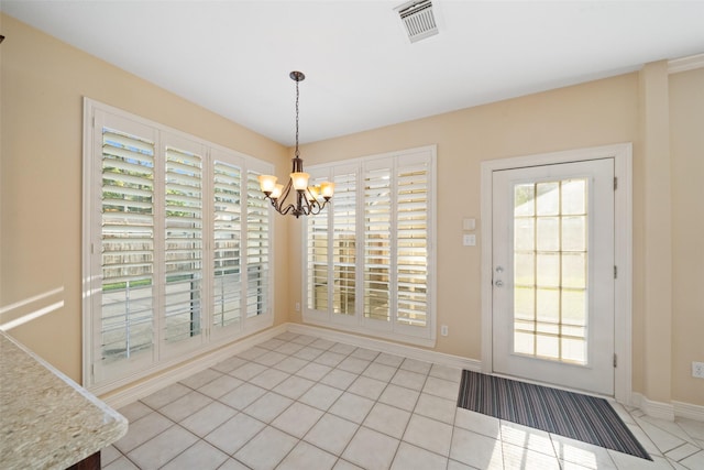 unfurnished dining area with light tile patterned floors, baseboards, visible vents, and an inviting chandelier