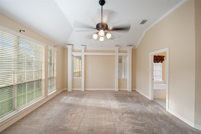 empty room featuring ceiling fan, visible vents, crown molding, vaulted ceiling, and carpet