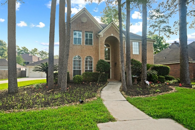 traditional-style home featuring brick siding and driveway