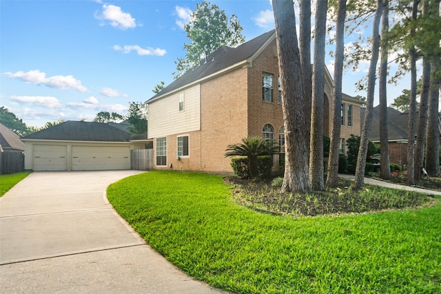 view of side of property featuring a lawn and driveway