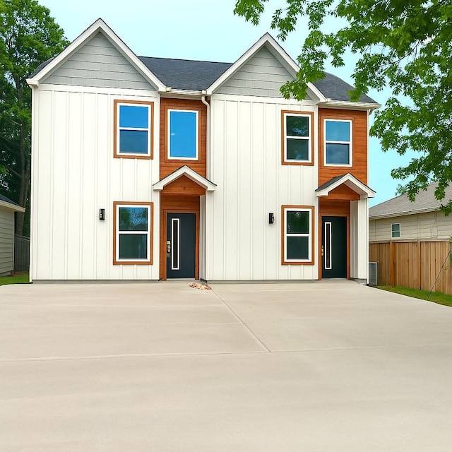 view of front of home featuring a patio, central AC unit, board and batten siding, and fence