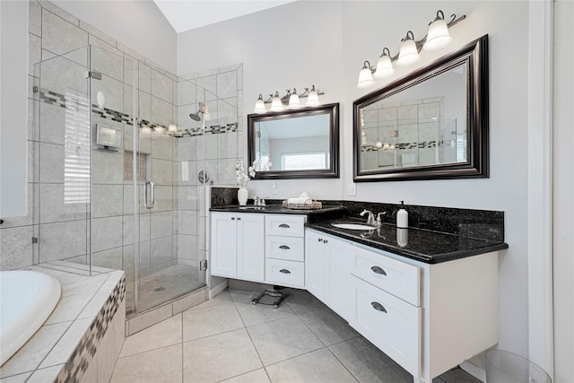 full bath featuring double vanity, a garden tub, tile patterned flooring, a shower stall, and a sink