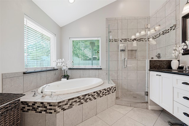 full bathroom featuring a garden tub, a stall shower, vanity, tile patterned floors, and lofted ceiling