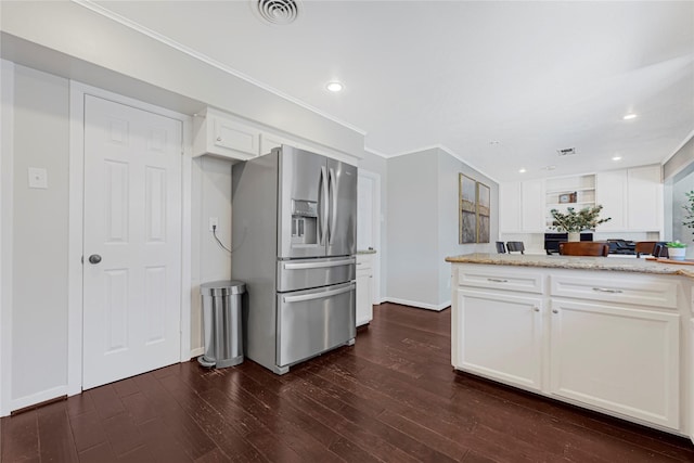 kitchen with visible vents, white cabinetry, dark wood-style flooring, and stainless steel fridge with ice dispenser