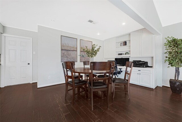 dining room with crown molding, dark wood finished floors, and visible vents