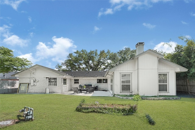 rear view of house featuring a yard, fence, and a patio area