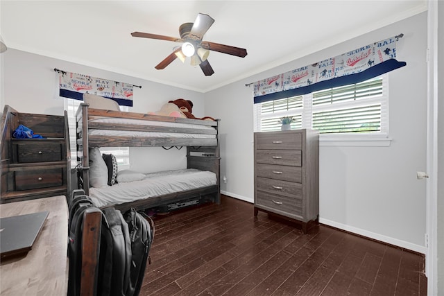 bedroom with baseboards, ceiling fan, ornamental molding, and wood finished floors