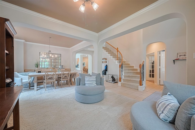 living area with stairs, arched walkways, crown molding, and light tile patterned floors