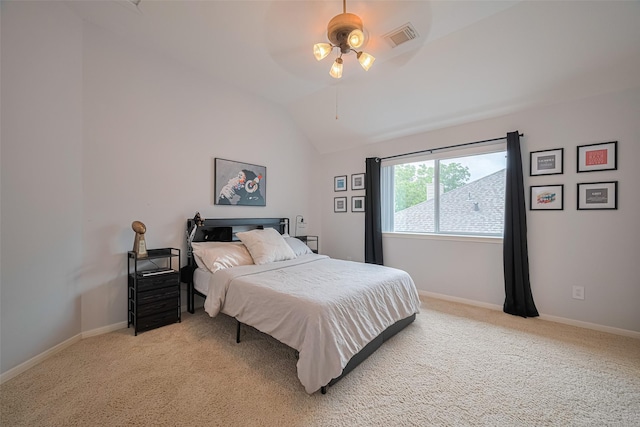bedroom with visible vents, baseboards, lofted ceiling, and light carpet