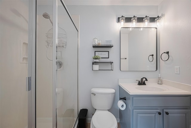 full bath featuring vanity, a stall shower, and toilet