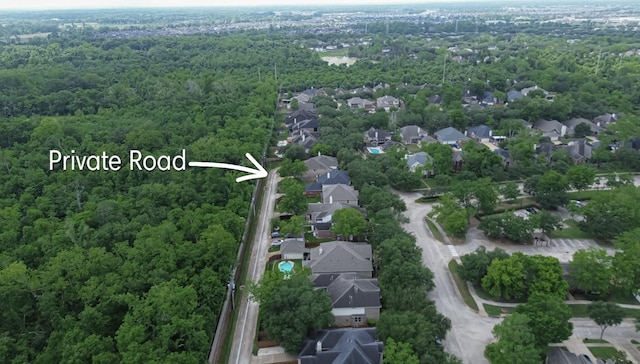 birds eye view of property featuring a residential view and a forest view