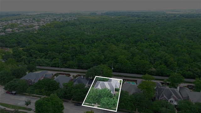 bird's eye view featuring a residential view and a wooded view