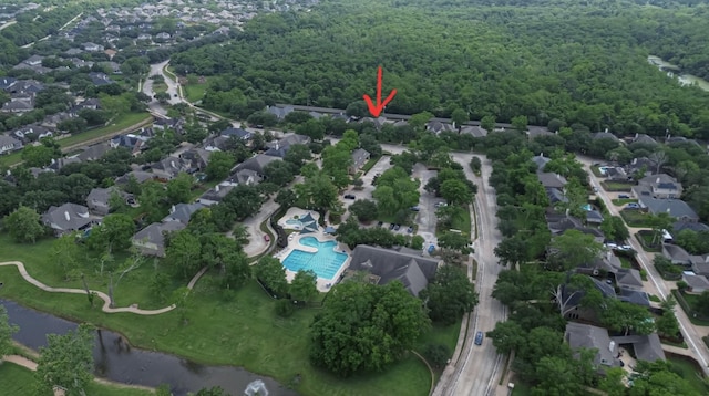 aerial view featuring a residential view, a view of trees, and a water view