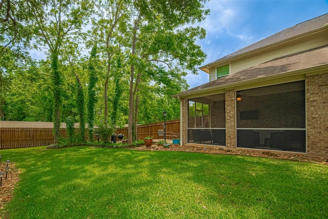view of yard with a fenced backyard and a sunroom