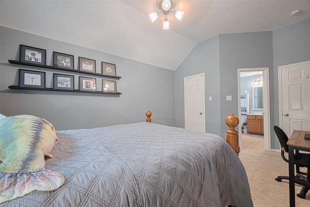 bedroom featuring connected bathroom, vaulted ceiling, and light carpet