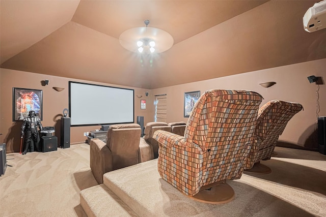 home theater with light carpet and vaulted ceiling