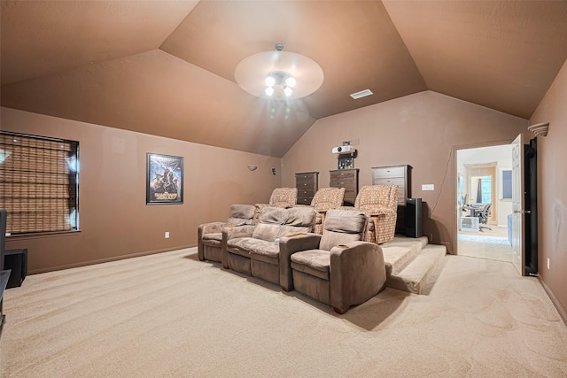 home theater with carpet floors, visible vents, baseboards, and lofted ceiling