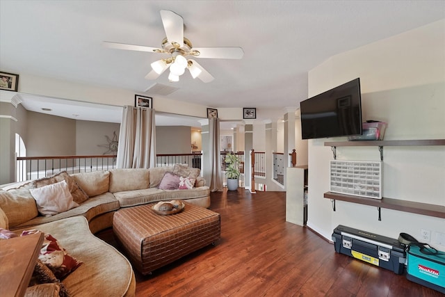living area with visible vents, a ceiling fan, and wood finished floors