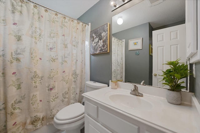 bathroom featuring toilet, a shower with shower curtain, and vanity