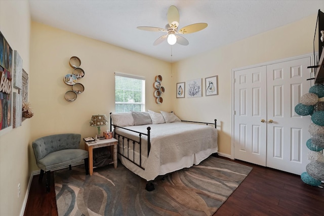 bedroom featuring a closet, baseboards, ceiling fan, and wood finished floors
