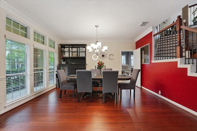 dining space featuring visible vents, wood finished floors, stairway, an inviting chandelier, and ornamental molding