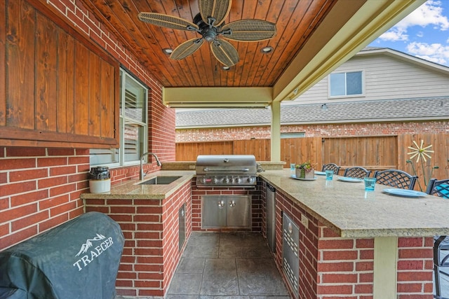 view of patio featuring grilling area, area for grilling, a sink, a fenced backyard, and outdoor wet bar