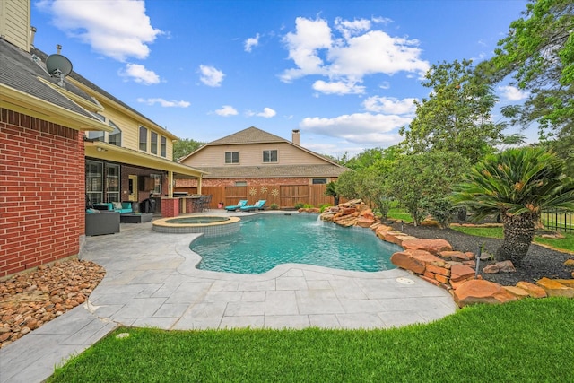 view of swimming pool featuring a patio, a pool with connected hot tub, outdoor lounge area, and a fenced backyard