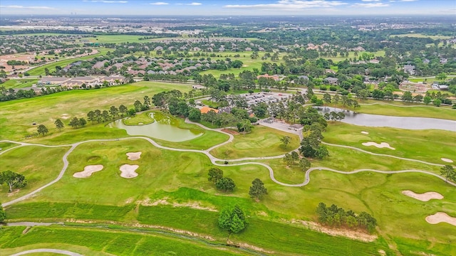 bird's eye view featuring a water view, view of golf course, and a residential view