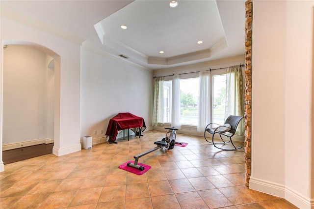 sitting room with crown molding, recessed lighting, a raised ceiling, and arched walkways